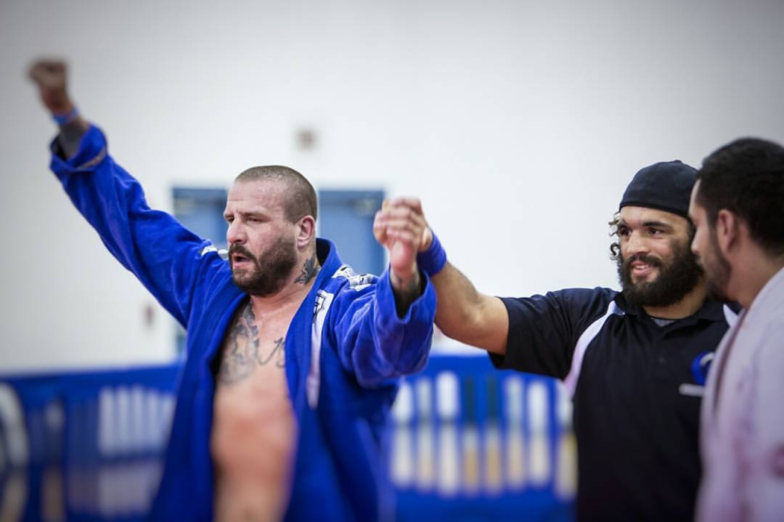 Sonny Parlin raising both arms as the referee lifts his hand after a gi match win