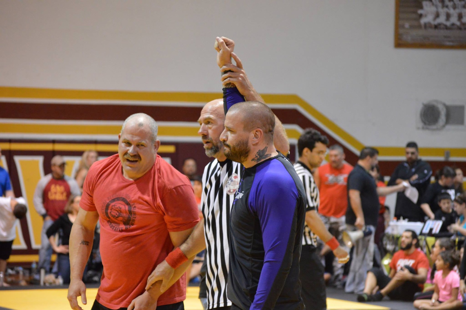 Referee raising Sonny Parlin's hand after a win