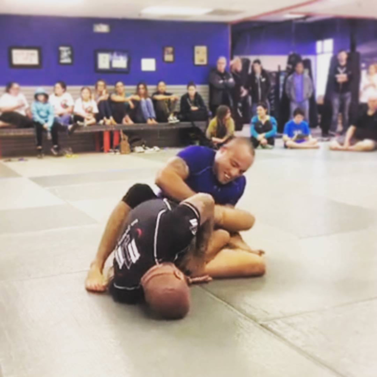 Sonny Parlin working from the top in an in-house tournament in front of a crowd of students