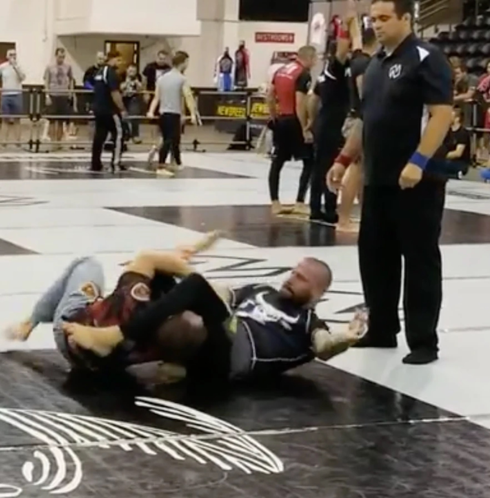Sonny Parlin in a black rashguard attacking a leg entanglement in a no-gi match