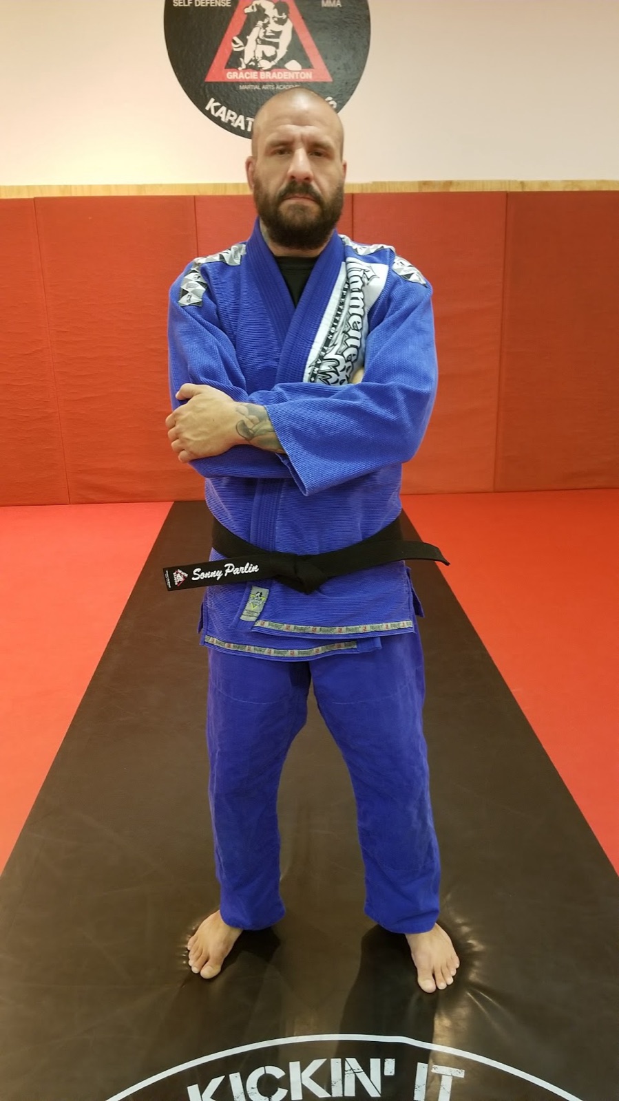 Sonny Parlin standing on the mat in a blue gi and black belt