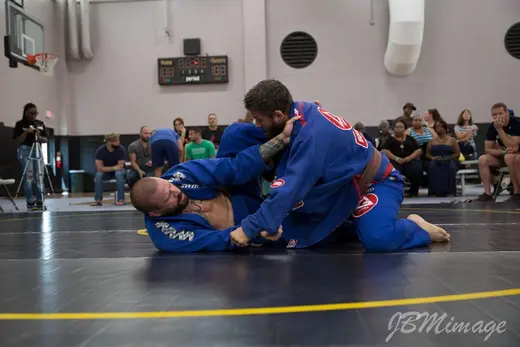 Gi match with both competitors in blue gis