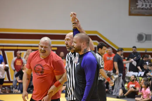 Referee raising Sonny Parlin's hand after a win