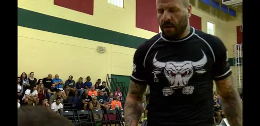 Sonny Parlin walking to the mat in a black rashguard